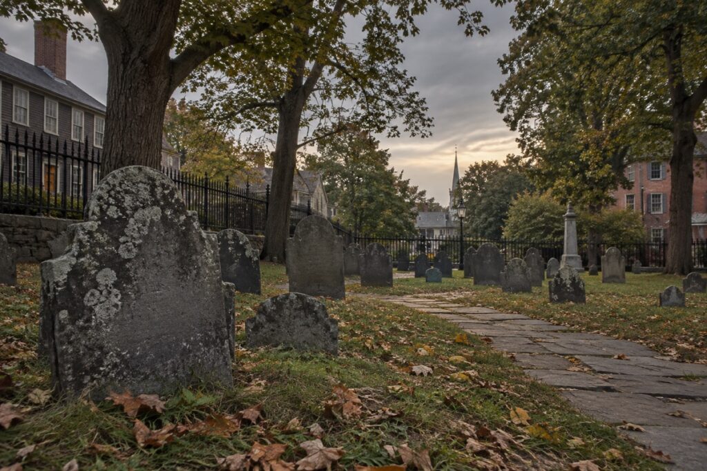 AI-created editorial interpretation of Howard Street Cemetery in Salem under an overcast sky