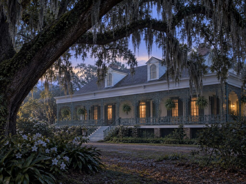 Editorial illustration of the Myrtles’ veranda framed by live oaks at twilight